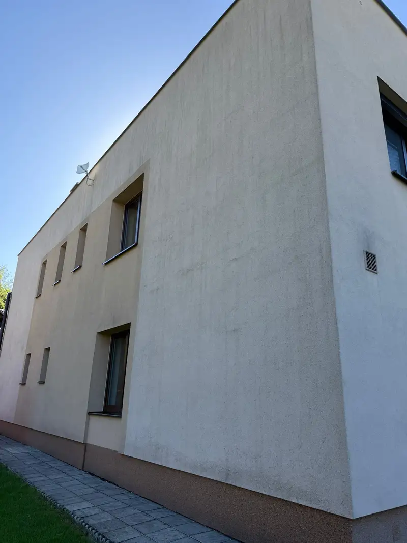 Omítaná fasáda před čištěním s tmavými svislými stopami